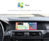 Movyro wireless Apple CarPlay retrofit device for BMW with Android Auto integration, shown connected inside a car dashboard.
